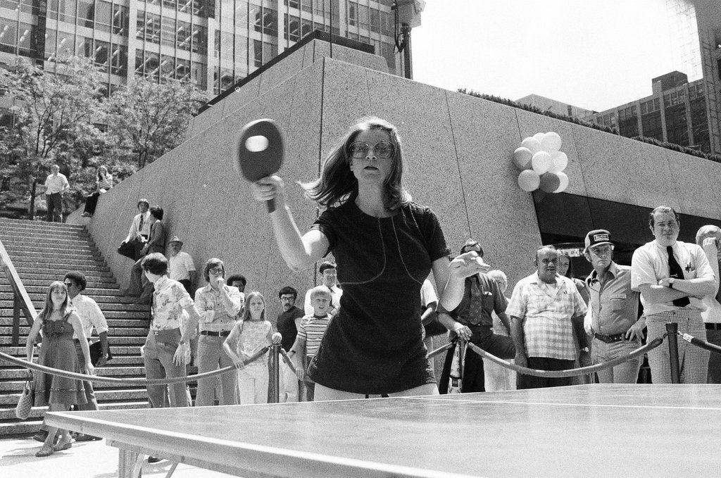 Three table tennis champions challenge individuals from the audience at a table tennis competition - Chicago Sun-Times