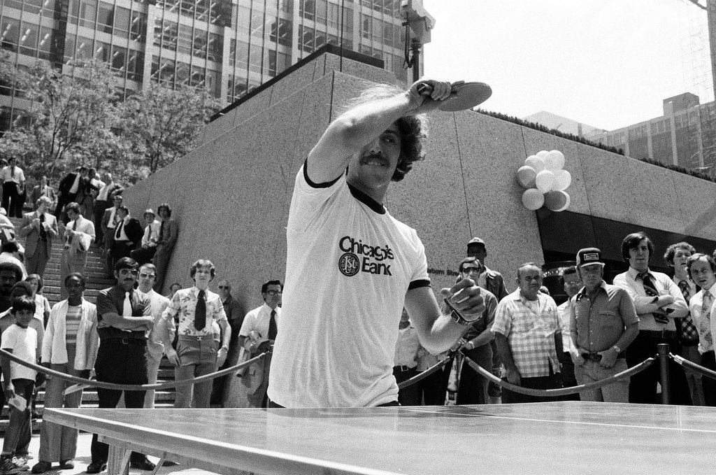 Three table tennis champions challenge individuals from the audience at a table tennis competition - Chicago Sun-Times
