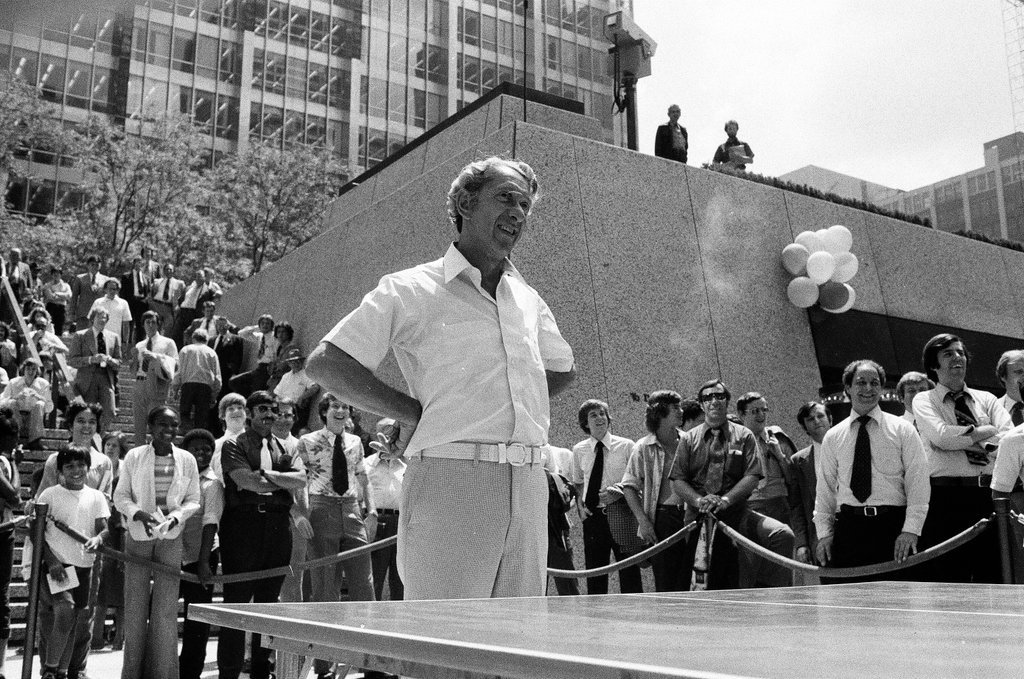 Three table tennis champions challenge individuals from the audience at a table tennis competition - Chicago Sun-Times