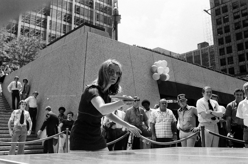 Three table tennis champions challenge individuals from the audience at a table tennis competition - Chicago Sun-Times