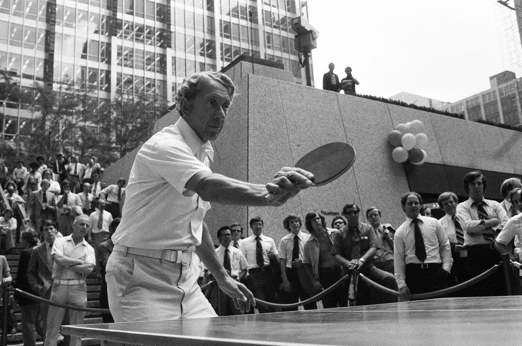 Three table tennis champions challenge individuals from the audience at a table tennis competition - Chicago Sun-Times