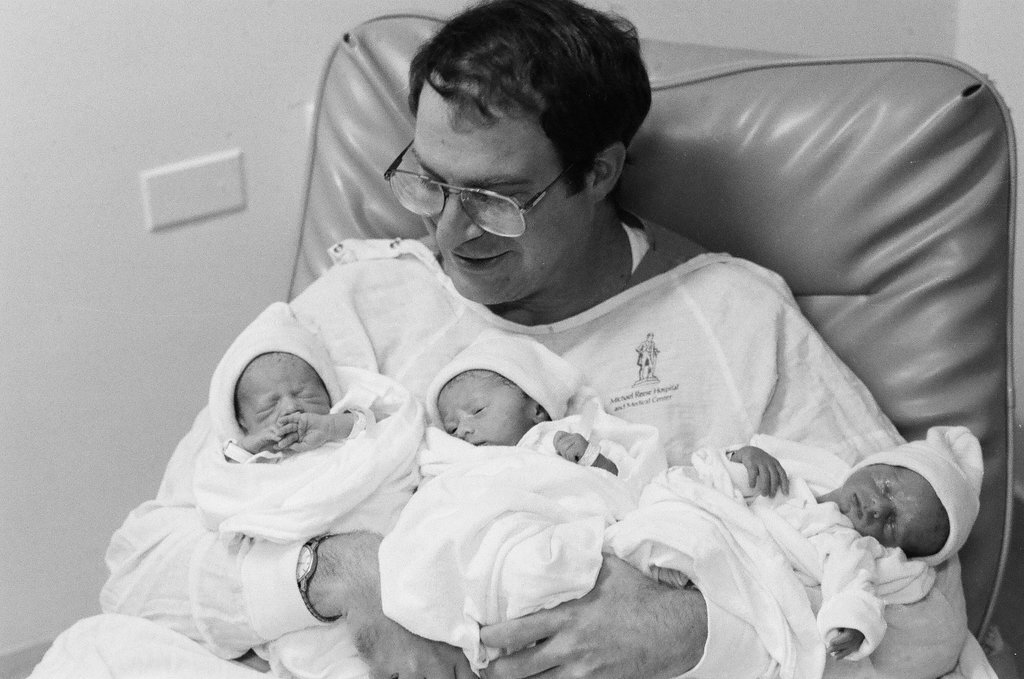 John Cronin holds his newborn triplets at Michael Reese Hospital - Chicago Sun-Times