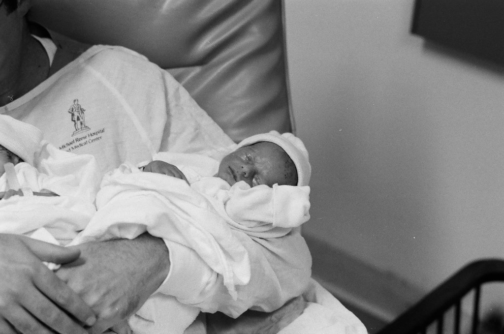 John Cronin holds his newborn triplets at Michael Reese Hospital - Chicago Sun-Times
