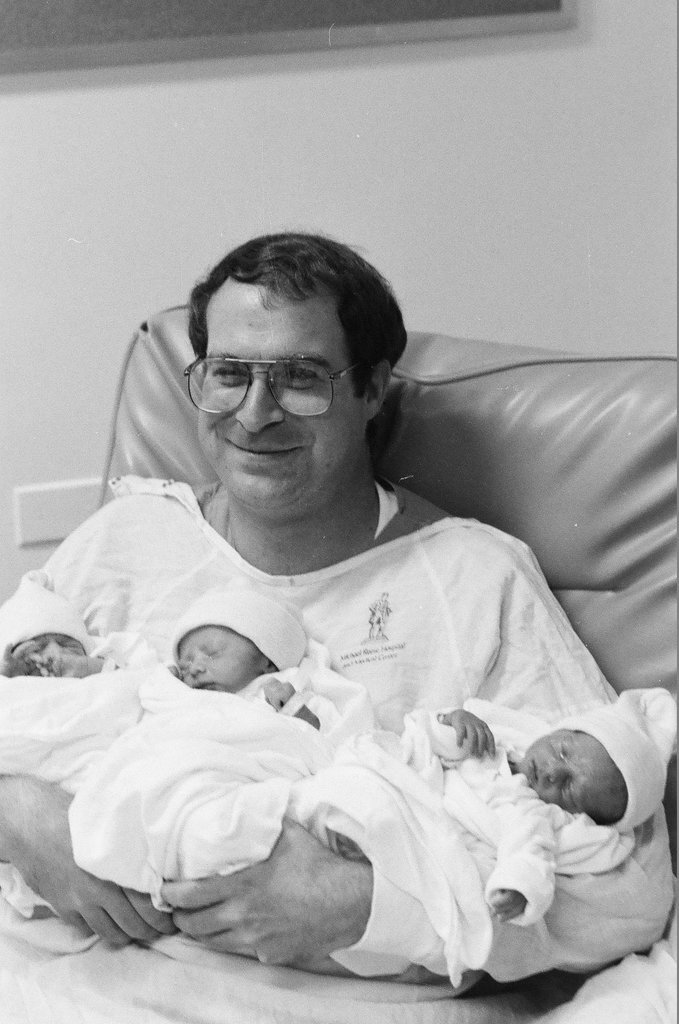 John Cronin holds his newborn triplets at Michael Reese Hospital - Chicago Sun-Times