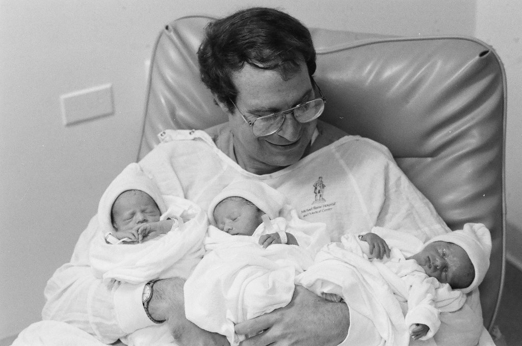 John Cronin holds his newborn triplets at Michael Reese Hospital - Chicago Sun-Times