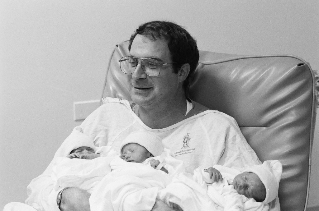 John Cronin holds his newborn triplets at Michael Reese Hospital - Chicago Sun-Times