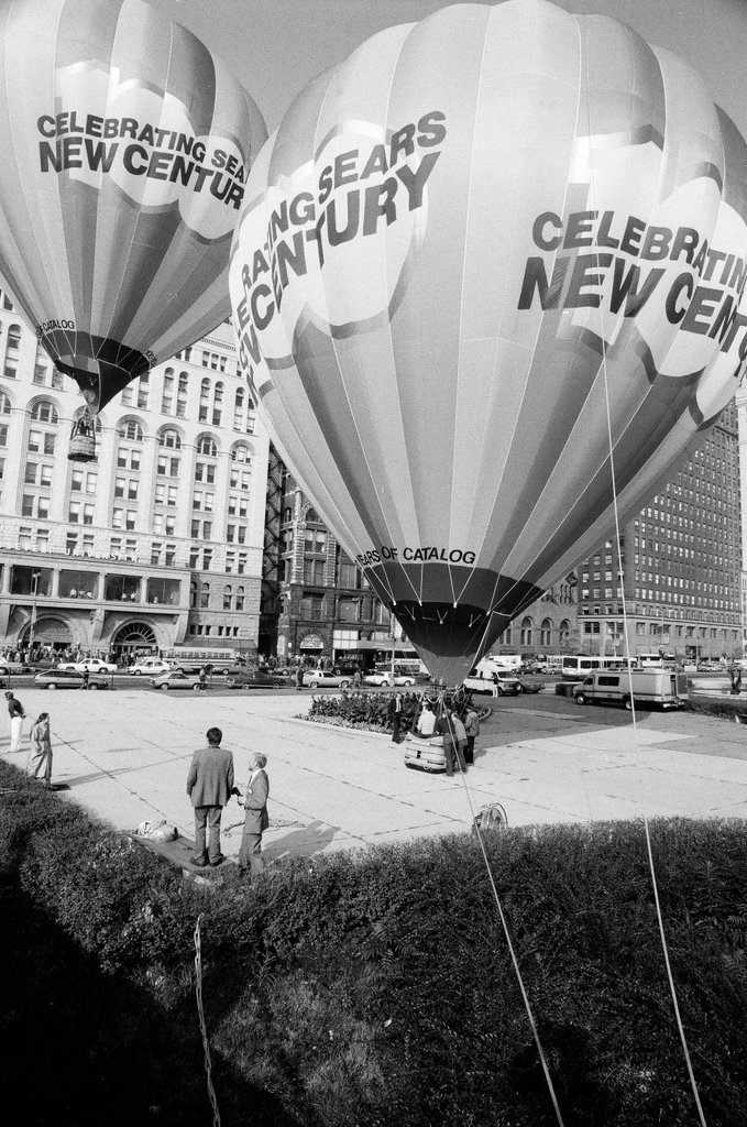 Crowds watch as a hot air balloon lifts off for the Sears 100th anniversary - Chicago Sun-Times