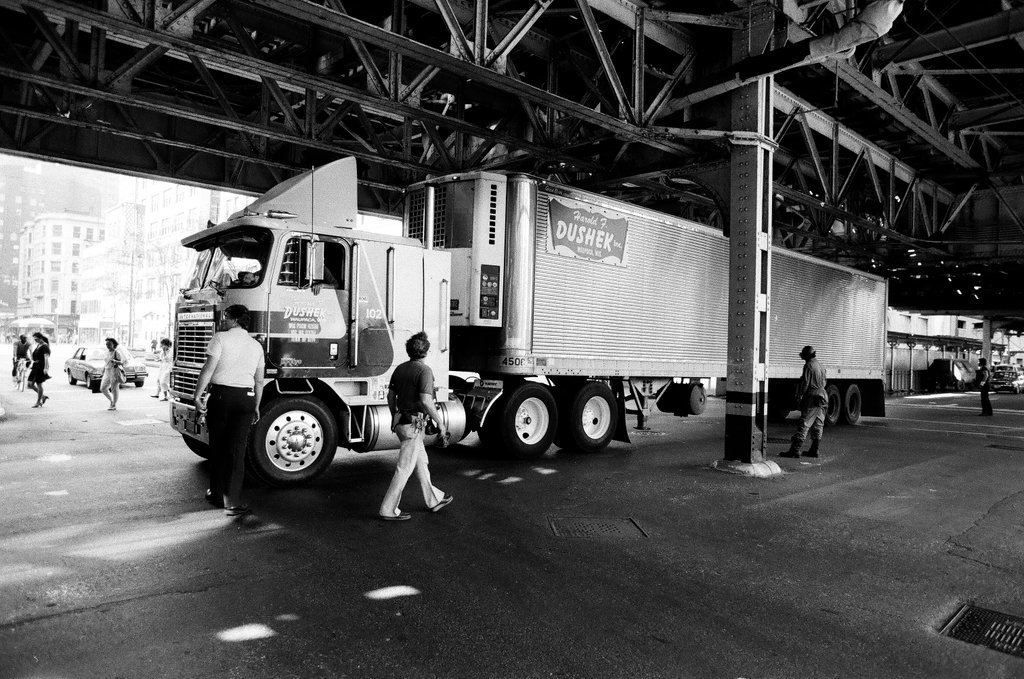 A freight truck is wedged underneath the 