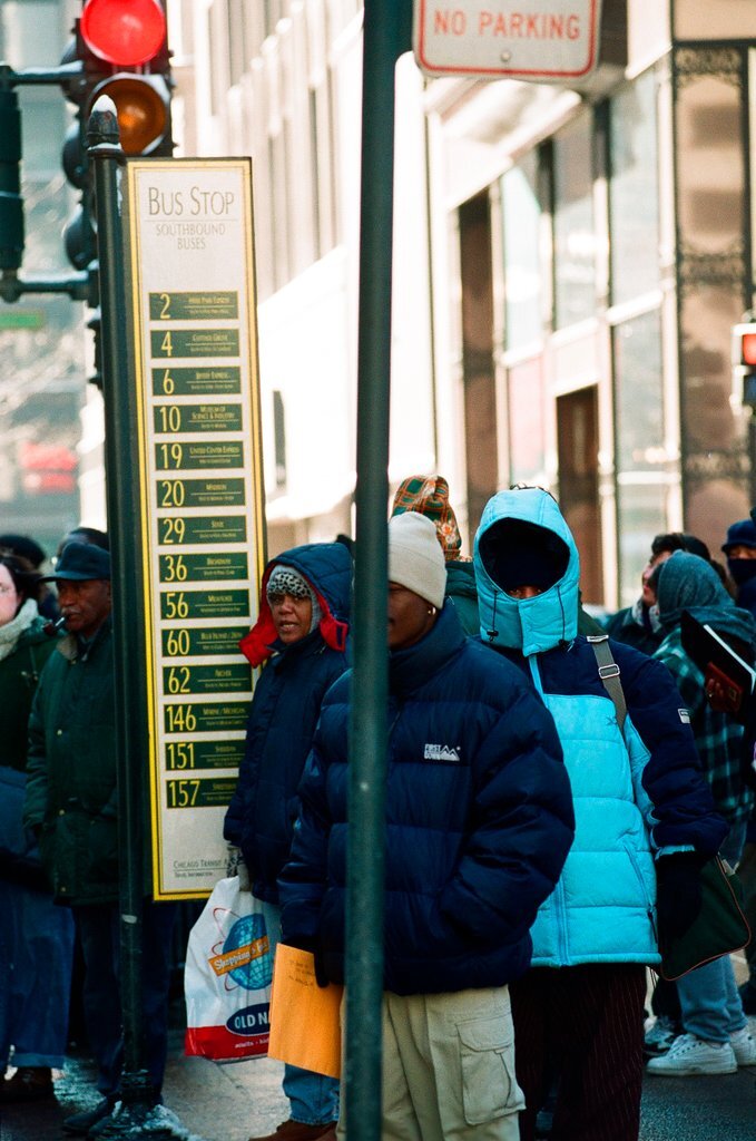 People walk down State Street in the cold winter weather - Chicago Sun-Times