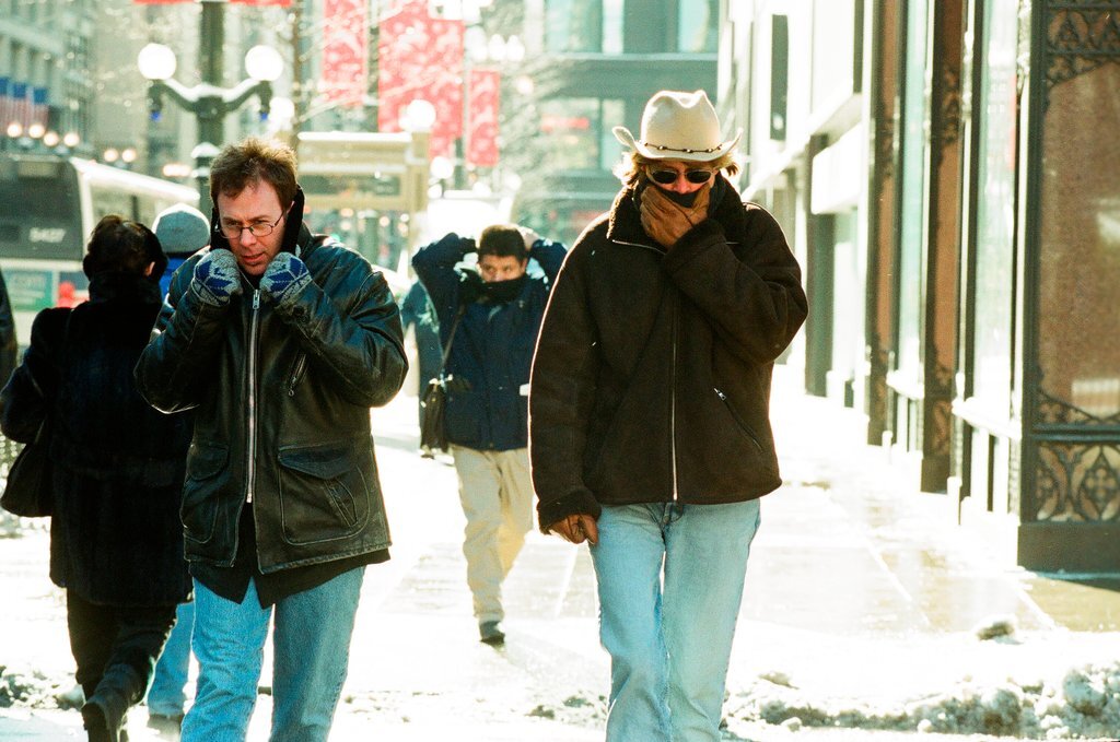People walk down State Street in the cold winter weather - Chicago Sun-Times