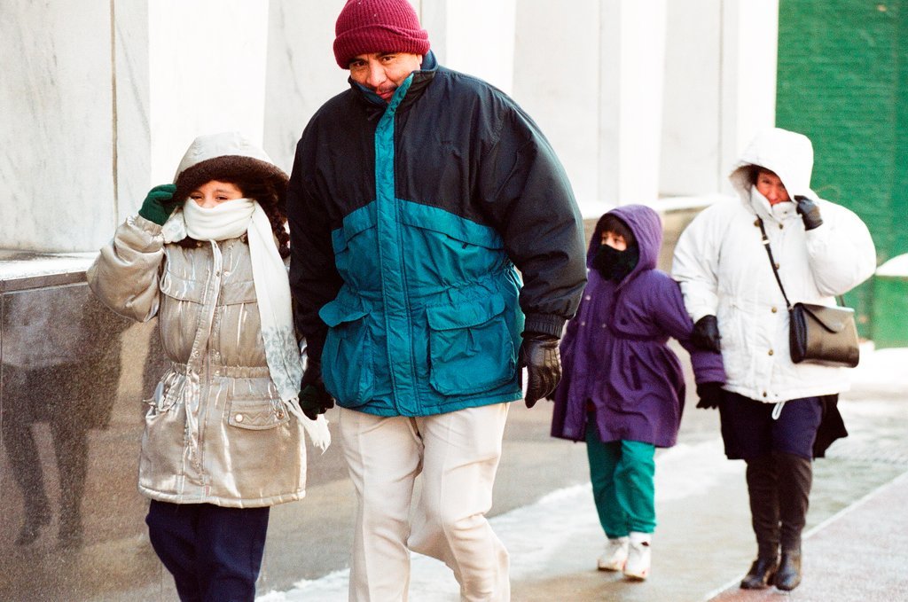 People walk down State Street in the cold winter weather - Chicago Sun-Times