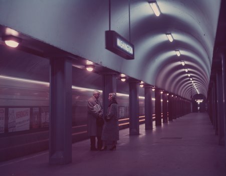 Color image of the Washington underground station. Features older man and woman on the platform near the tracks. - Deutch, Stephen