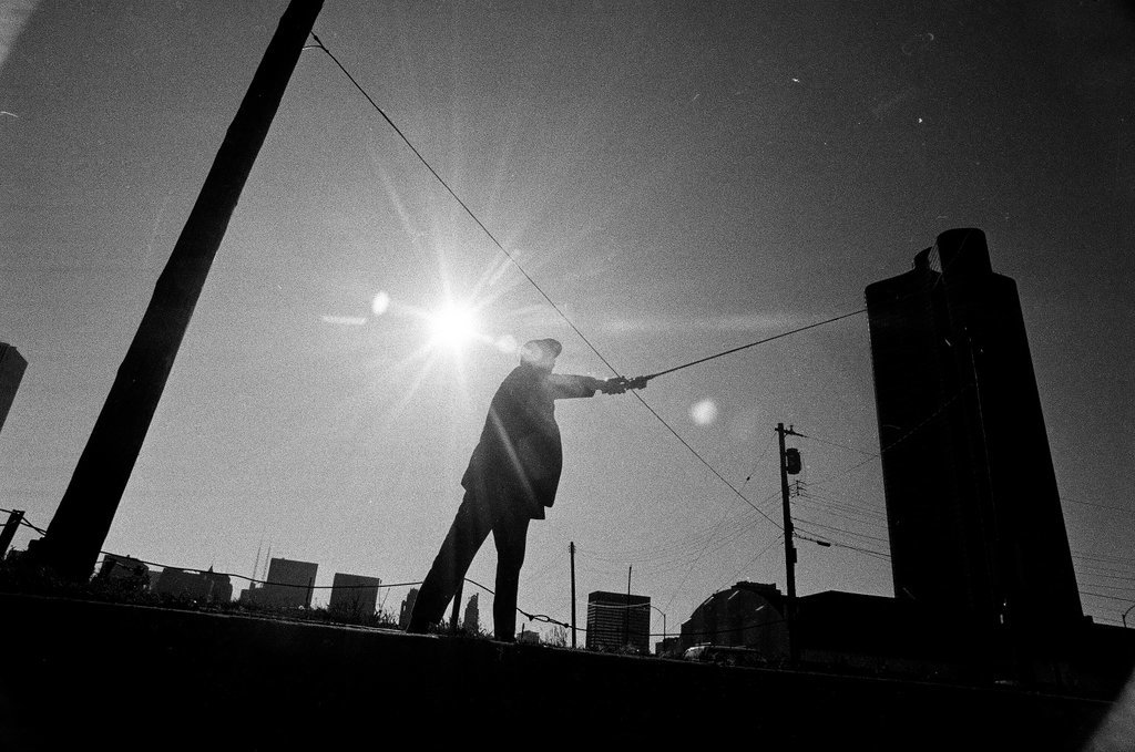 A man fishes at Navy Pier - Chicago Sun-Times